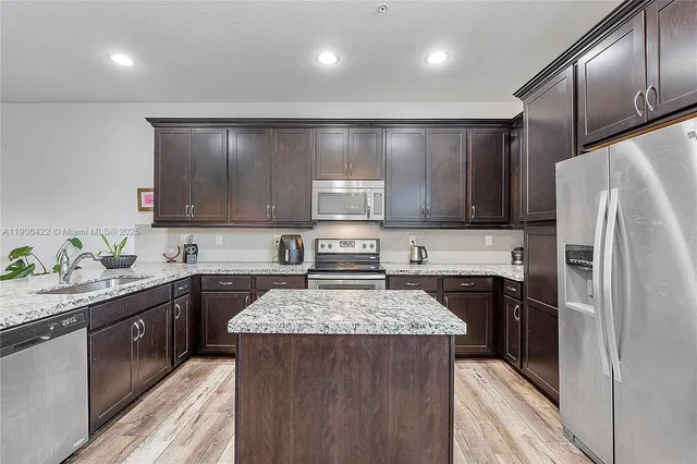 a kitchen with a sink stove and refrigerator