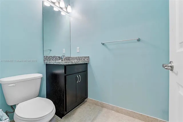 a bathroom with a toilet a sink and mirror