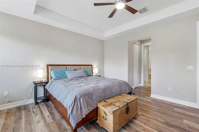 a bedroom with a bed and a ceiling fan