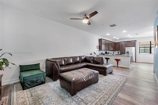 a living room with furniture and wooden floor