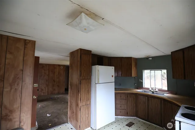 a kitchen with a refrigerator and a sink