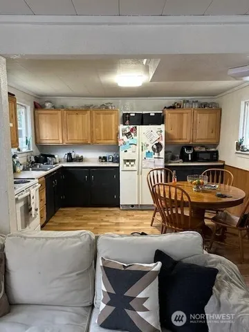 a view of kitchen with kitchen island stainless steel appliances wooden cabinets and counter space