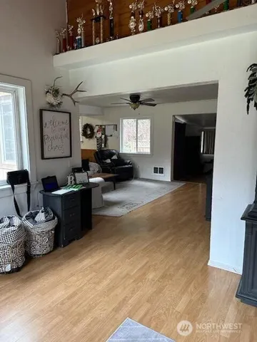 a living room with furniture window and dresser
