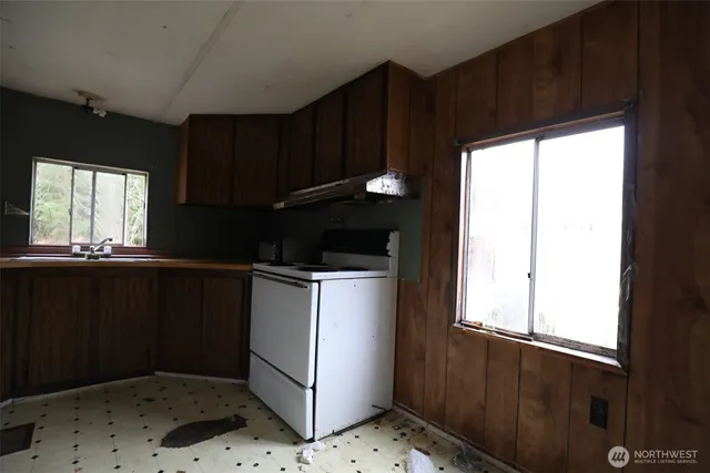 a kitchen with a refrigerator and window