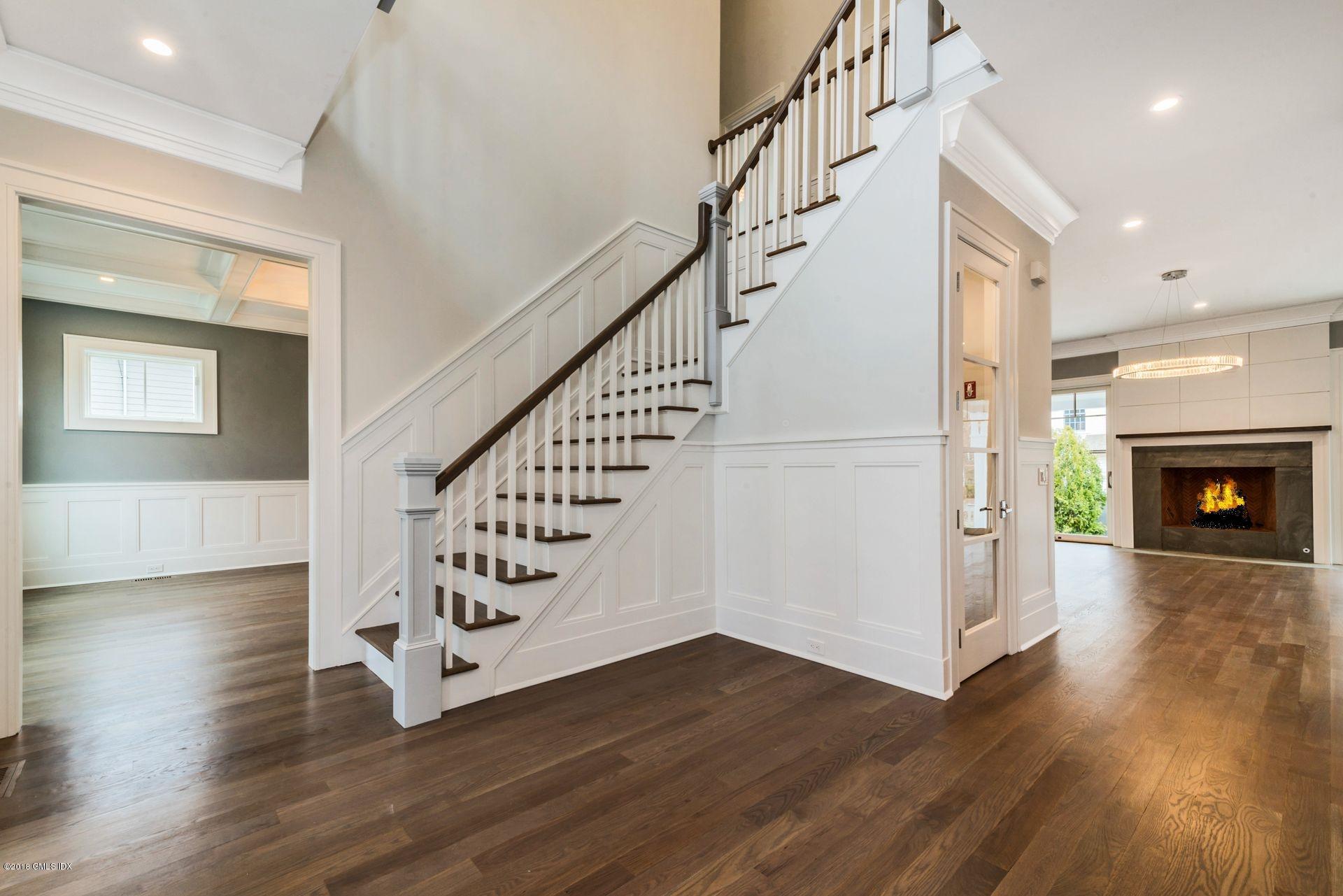 5 Club Road Riverside, CT 06878 - Photo 20 of 45 a view of a hallway with wooden floor staircase and a kitchen