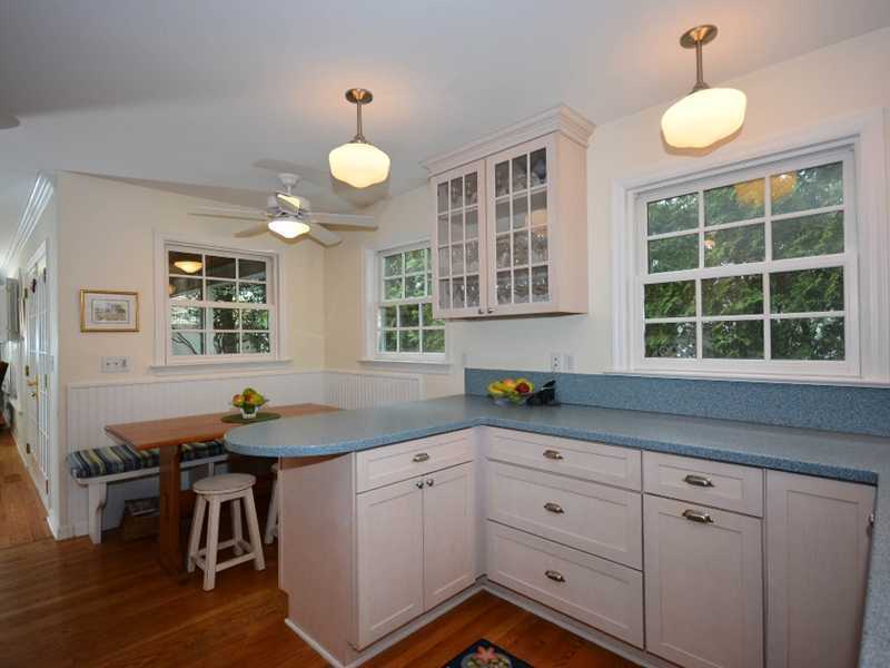12 Ensign Road Rowayton, CT 06853 - Photo 12 of 24 a kitchen with stainless steel appliances granite countertop white cabinets and window