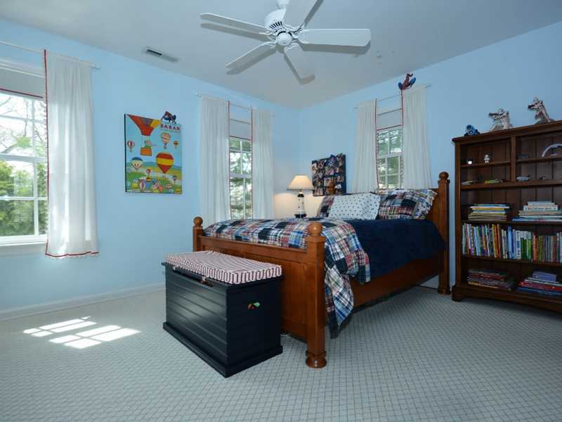 12 Ensign Road Rowayton, CT 06853 - Photo 19 of 24 a bed room with a bed and a book shelf