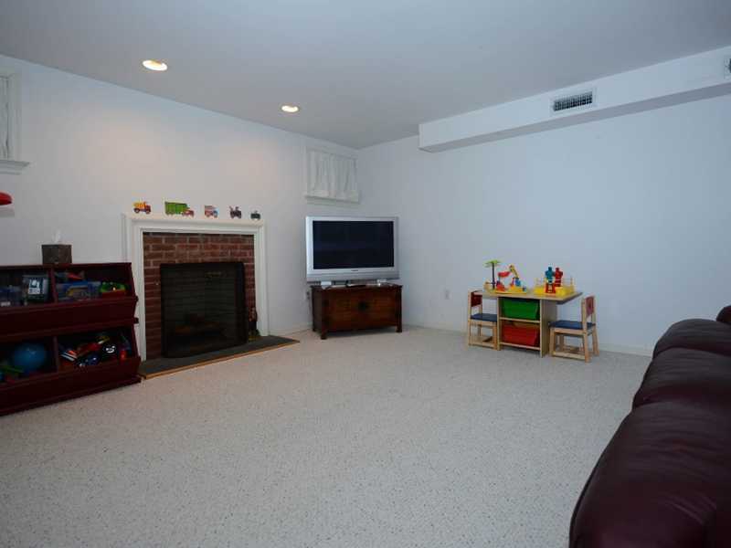 12 Ensign Road Rowayton, CT 06853 - Photo 22 of 24 a living room with furniture and a fireplace