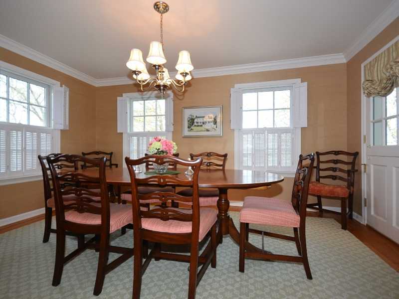 12 Ensign Road Rowayton, CT 06853 - Photo 10 of 24 a dining room filled chandelier and wooden furniture