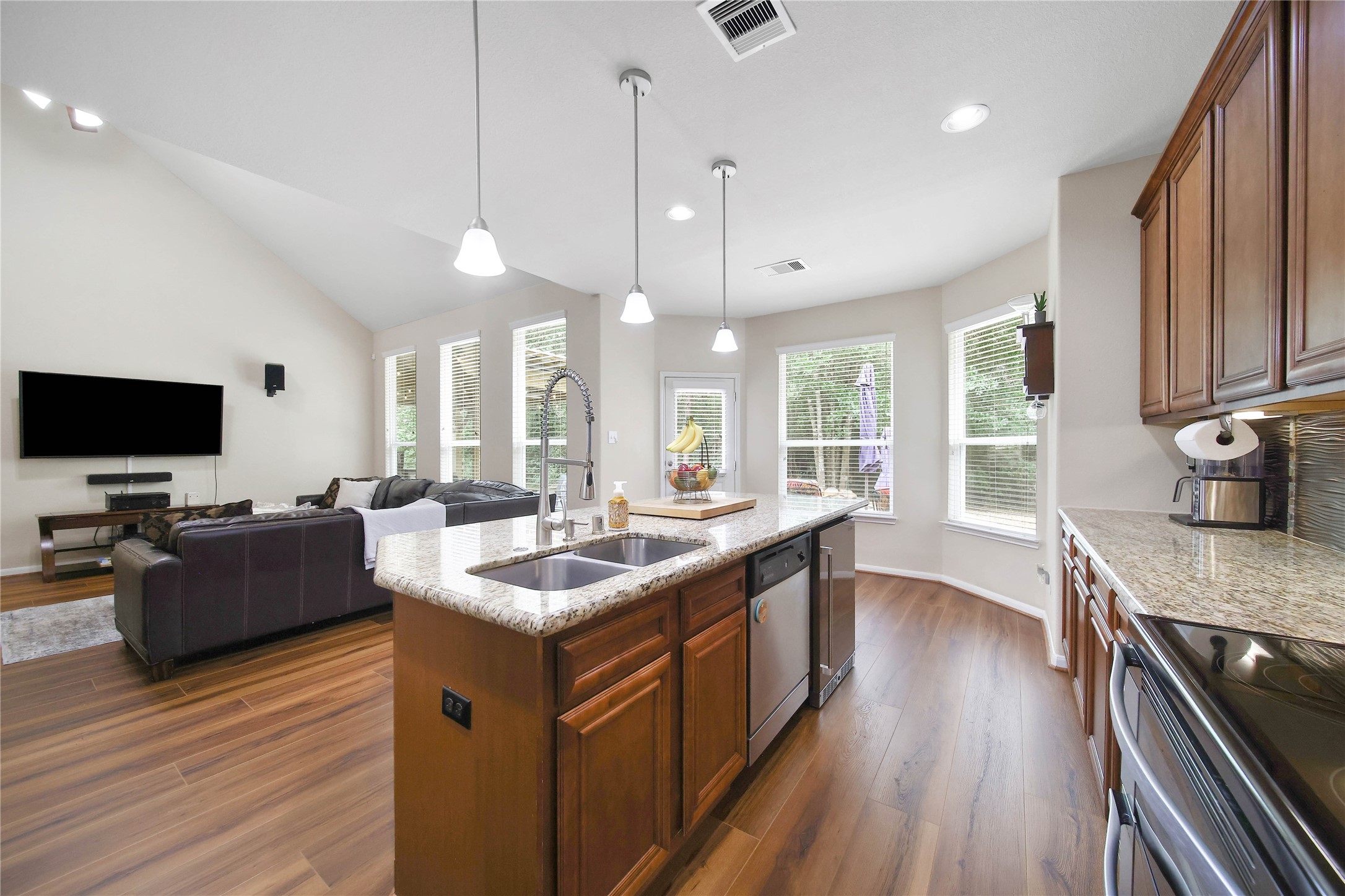 9223 Wapiti Trail Conroe, TX 77303 - Photo 20 of 45 a kitchen with sink stove and wooden floor