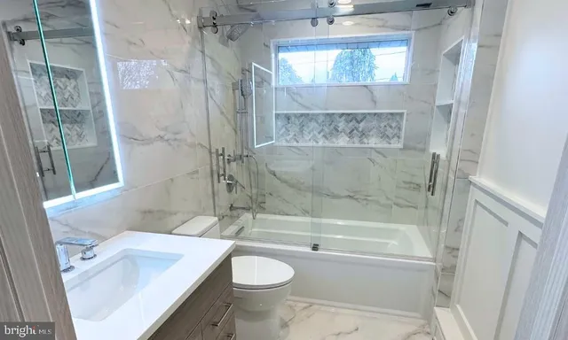 a bathroom with a sink toilet and shower
