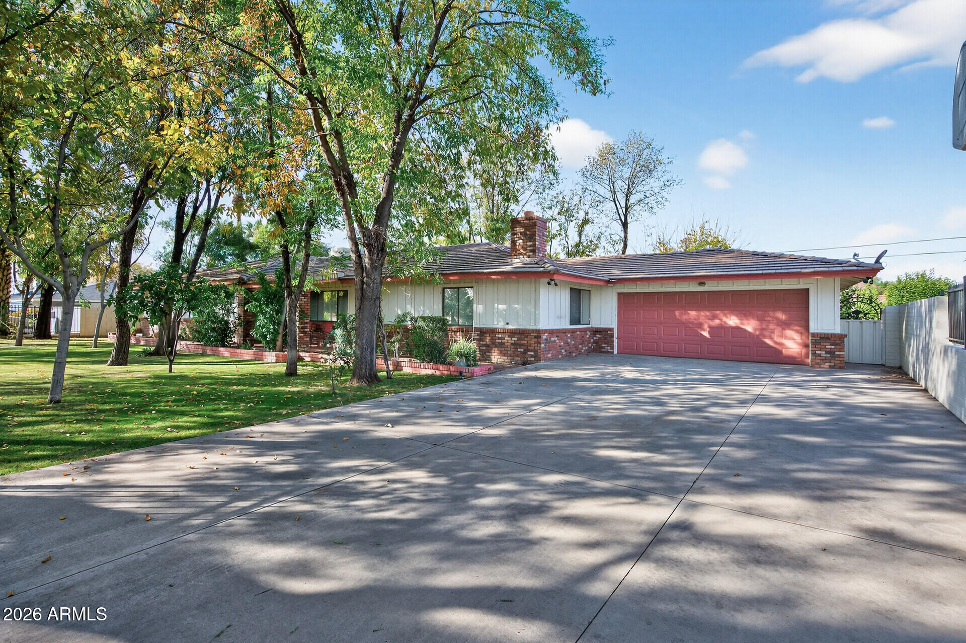 7730 North 7th Avenue Phoenix, AZ 85021 - Photo 1 of 14 a front view of a house with a garden