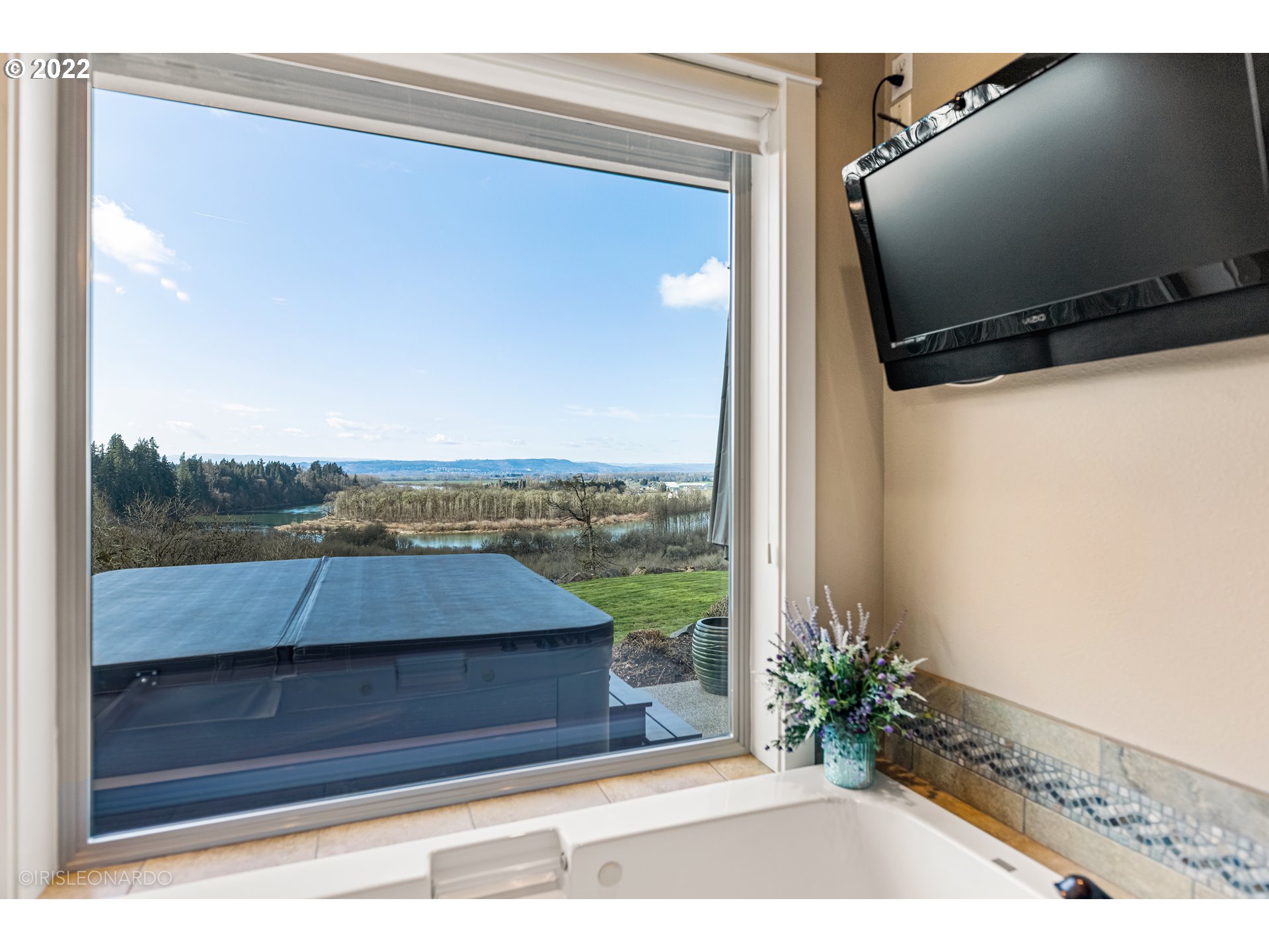 33806 Northwest Norstar Ranch Road Ridgefield, WA 98642 - Photo 19 of 32 a view of a balcony with floor to ceiling windows with wooden floor