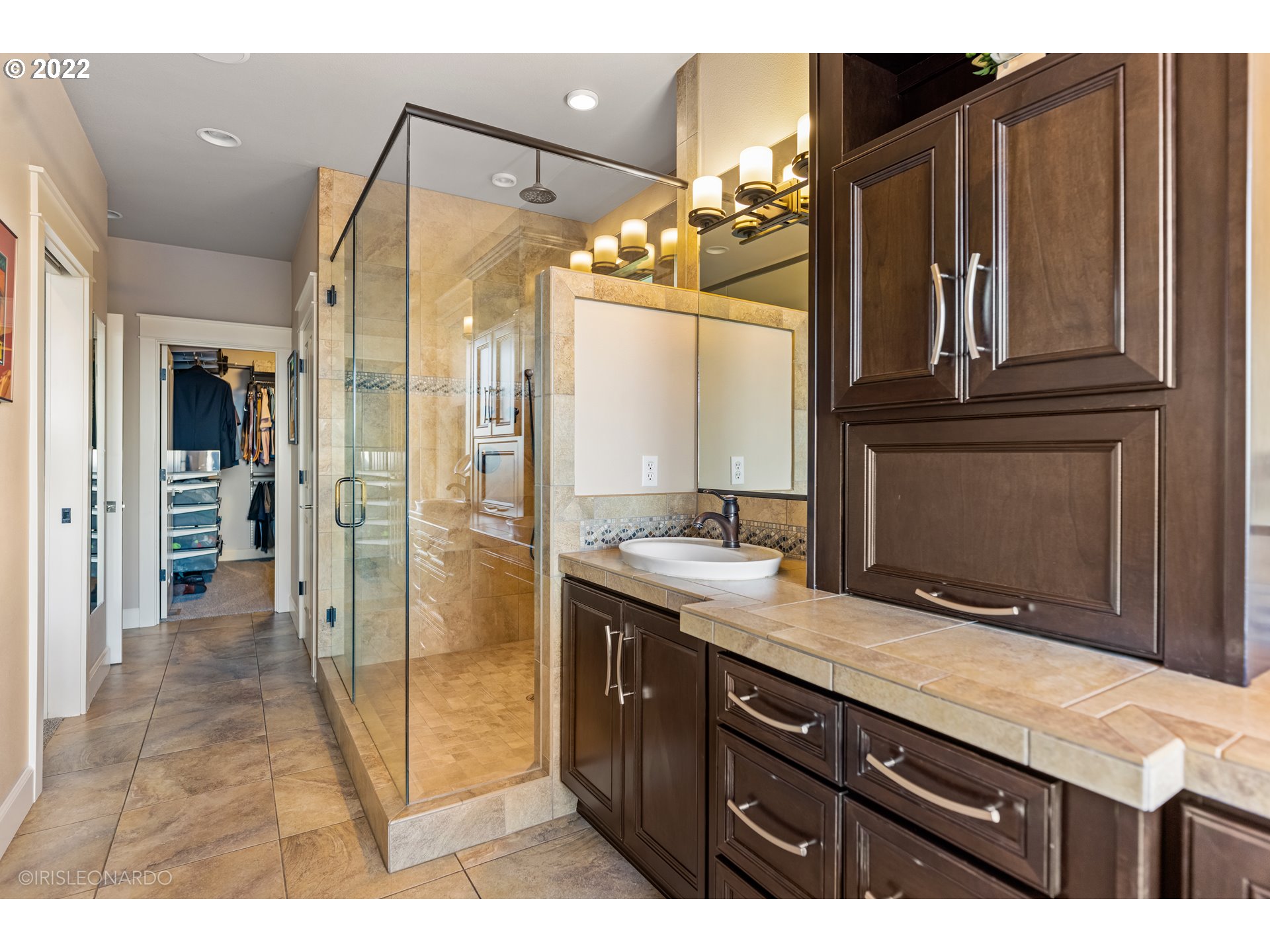 33806 Northwest Norstar Ranch Road Ridgefield, WA 98642 - Photo 20 of 32 a bathroom with a granite countertop sink shower and a mirror