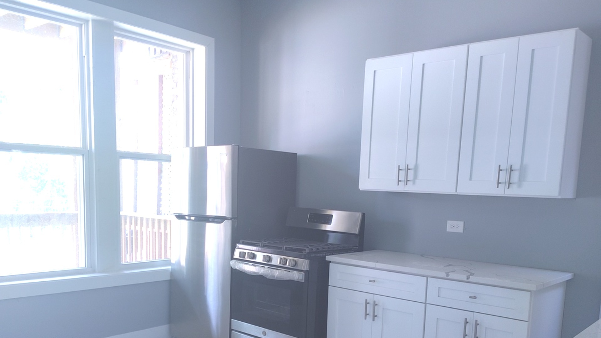 1661 South Homan Avenue, Unit GARDEN Chicago, IL 60623 - Photo 4 of 11 a kitchen with appliances cabinets and a window