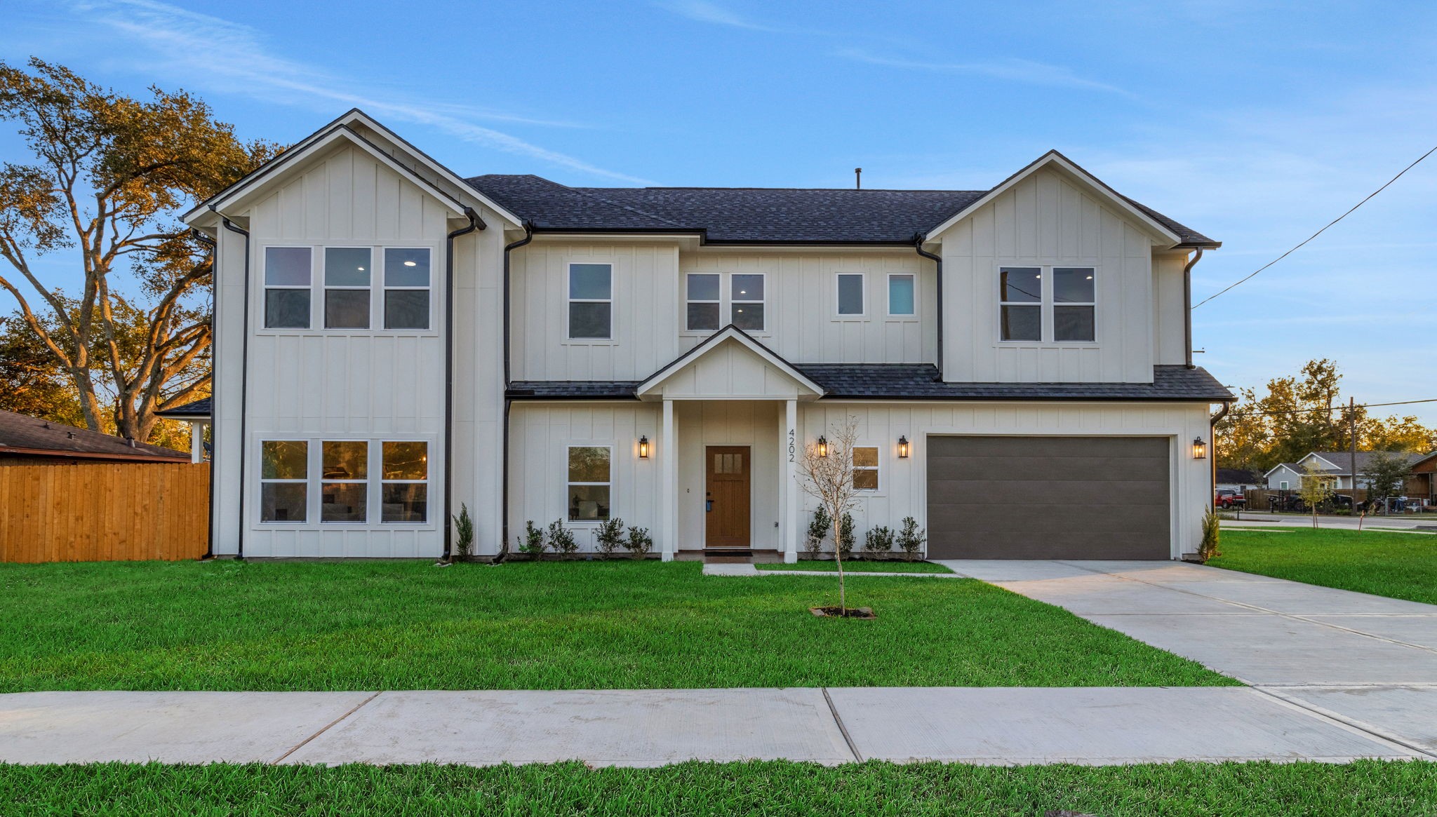 4202 Plaag Street Houston, TX 77016 - Photo 1 of 38 Sophisticated two-story residence on a prominent corner lot, showcasing bold architectural lines, curated landscaping, a wide driveway, and an attached two-car garage.