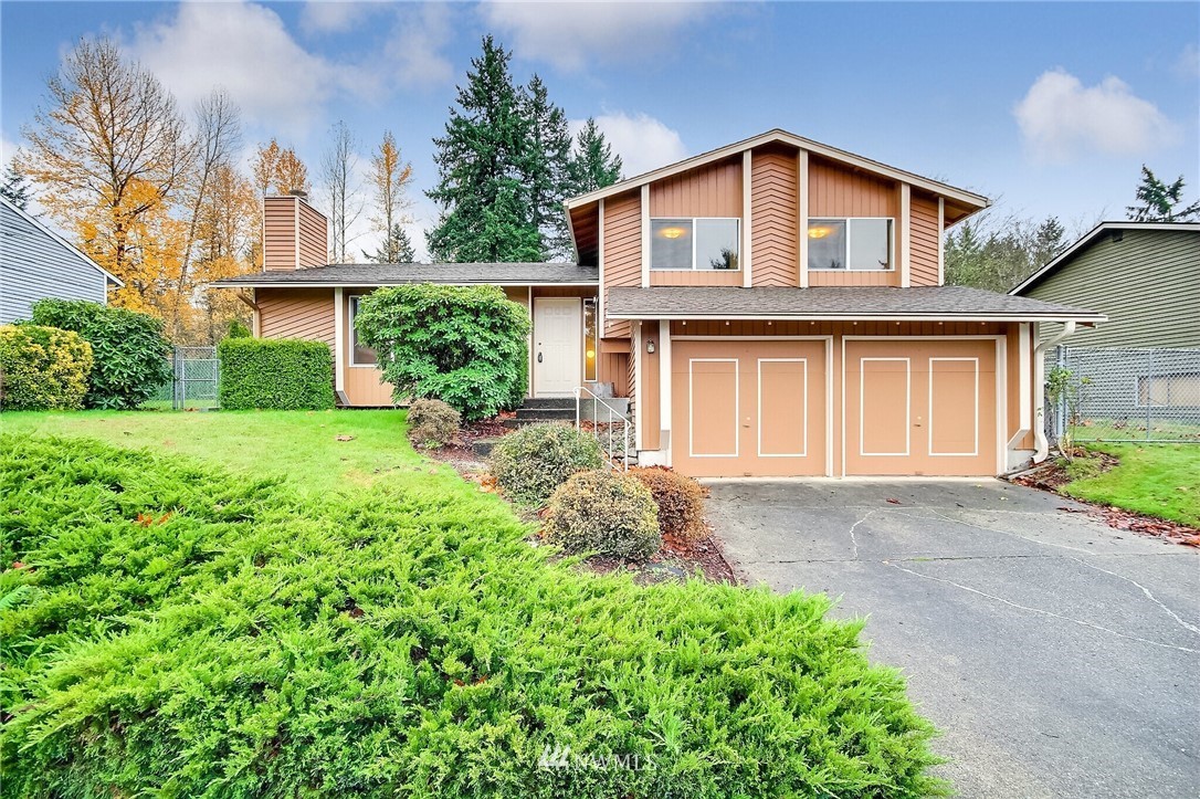 2209 Southeast 21st Street Renton, WA 98055 - Photo 1 of 40 a front view of a house with a yard and garage
