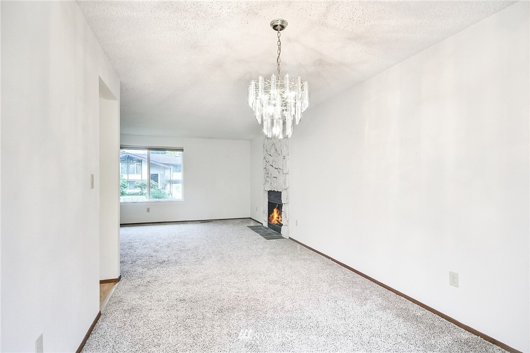 2209 Southeast 21st Street Renton, WA 98055 - Photo 12 of 40 an empty room with windows and chandelier