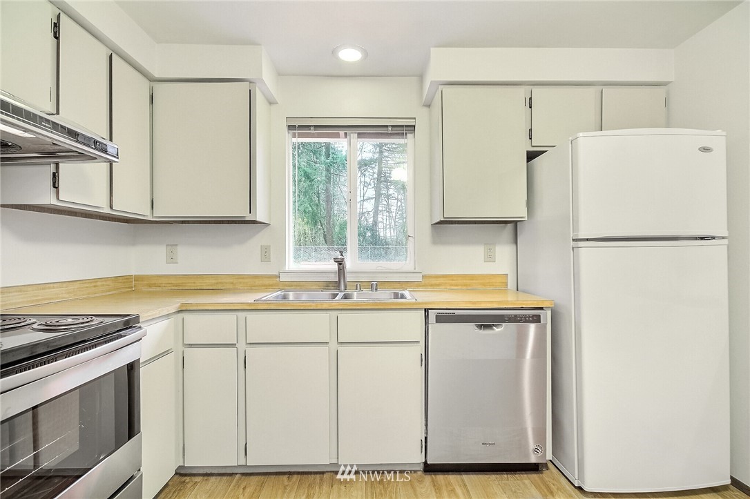 2209 Southeast 21st Street Renton, WA 98055 - Photo 15 of 40 a white refrigerator freezer sitting inside of a kitchen