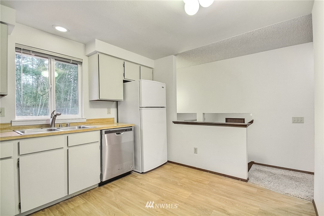 2209 Southeast 21st Street Renton, WA 98055 - Photo 16 of 40 a kitchen with white cabinets and white appliances