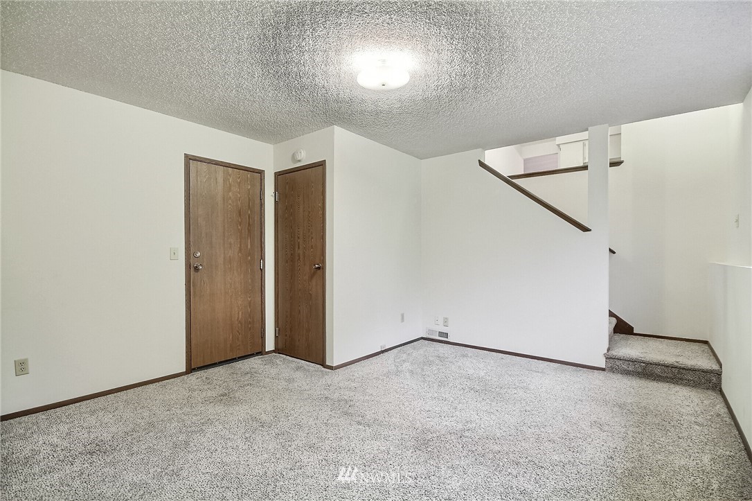 2209 Southeast 21st Street Renton, WA 98055 - Photo 29 of 40 an empty room with a ceiling fan and wooden floor