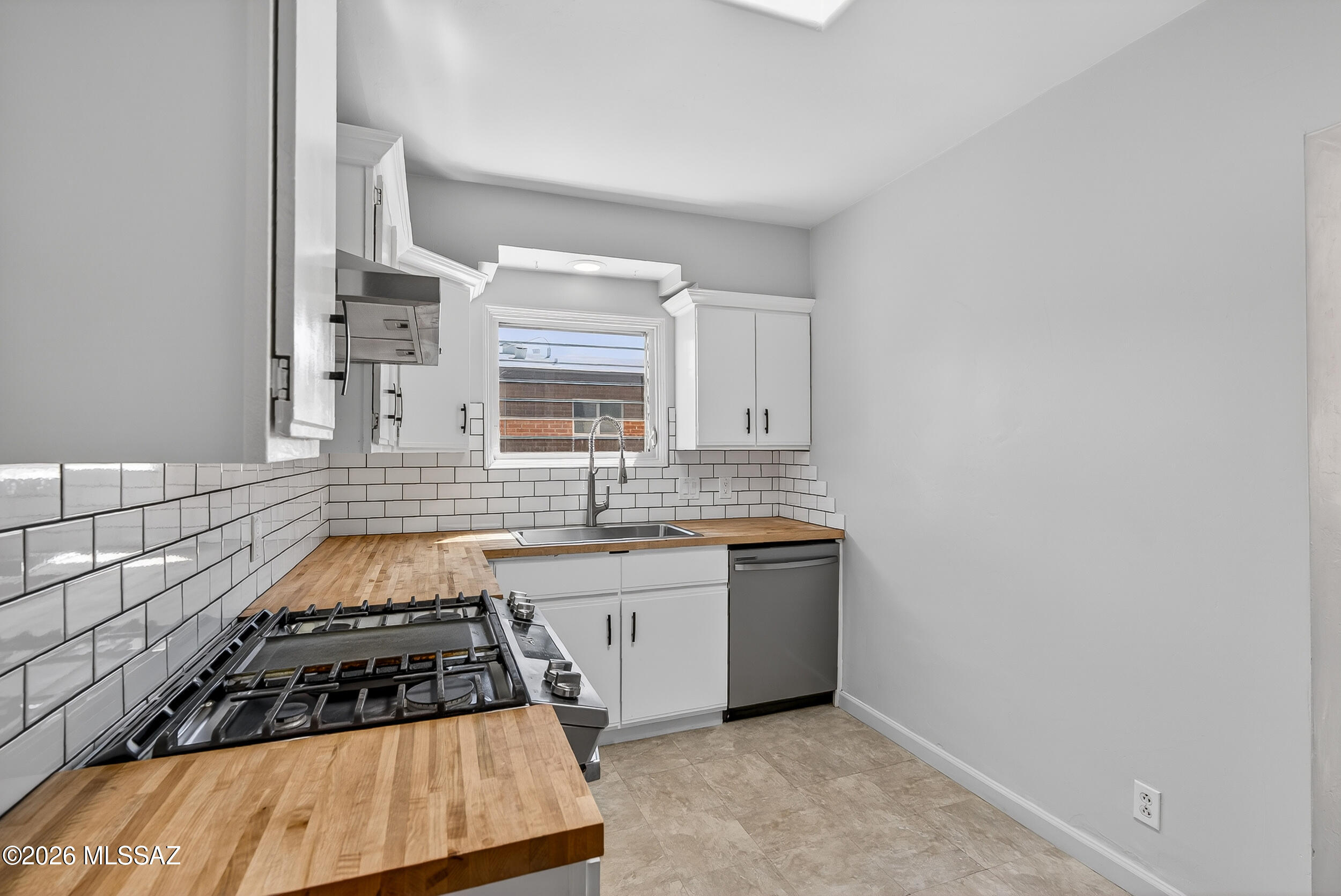 1412 East Spring Street Tucson, AZ 85719 - Photo 15 of 43 a kitchen with granite countertop a stove and a sink