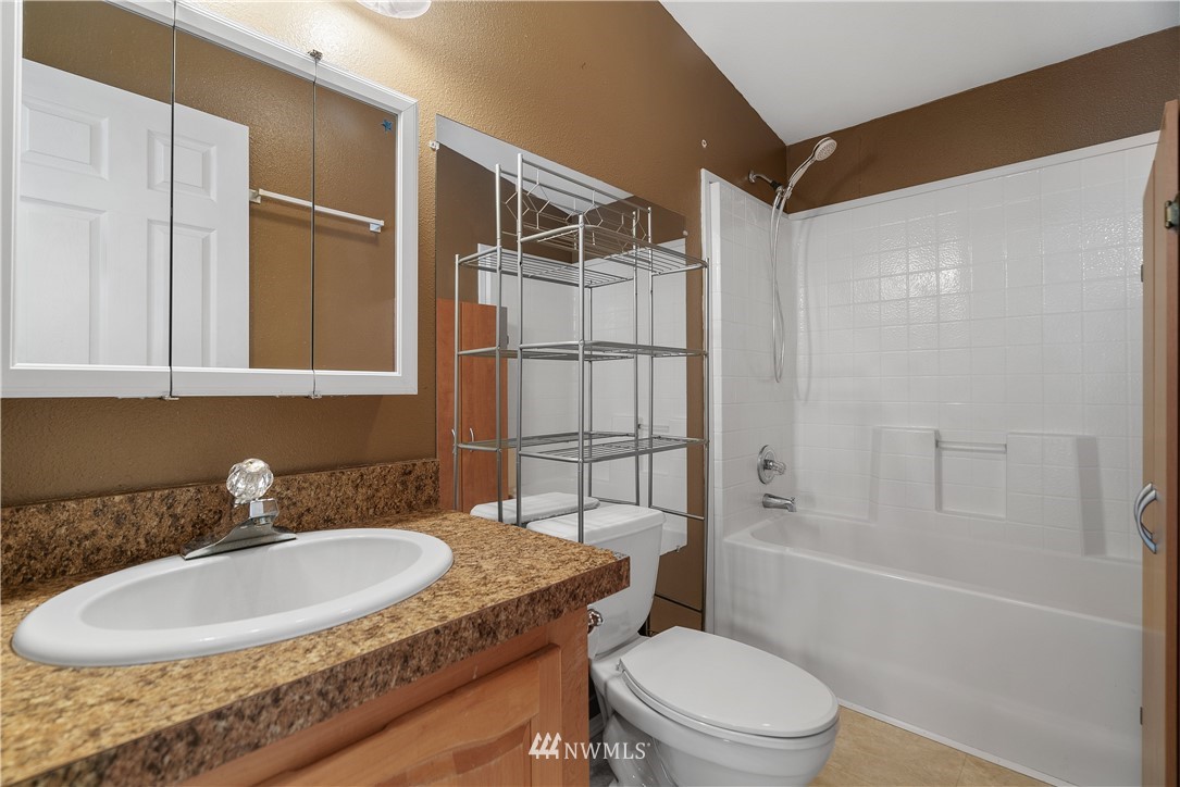 3925 183rd Avenue Southwest Rochester, WA 98579 - Photo 12 of 33 a bathroom with a granite countertop sink toilet and shower