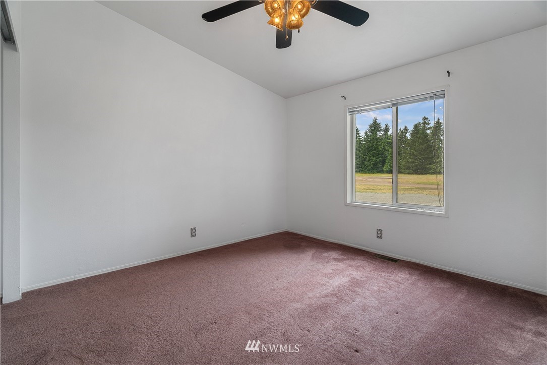 3925 183rd Avenue Southwest Rochester, WA 98579 - Photo 13 of 33 an empty room with a window and a ceiling fan