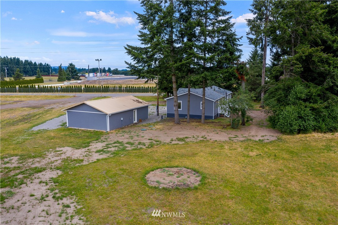 3925 183rd Avenue Southwest Rochester, WA 98579 - Photo 28 of 33 a swimming pool with lawn chairs and large trees