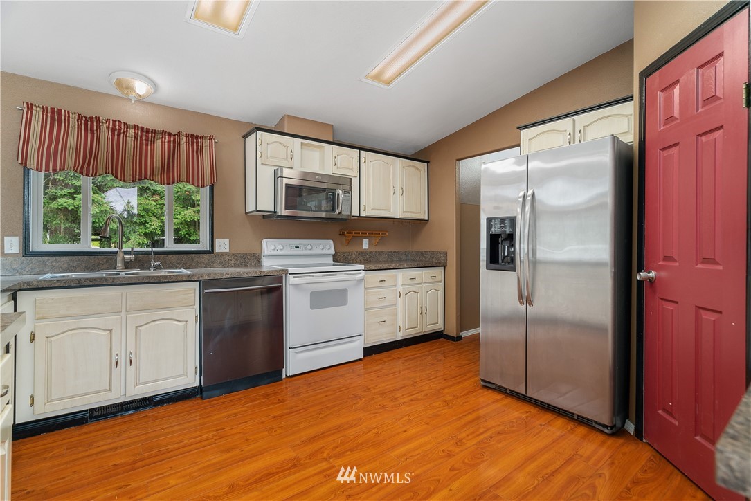 3925 183rd Avenue Southwest Rochester, WA 98579 - Photo 5 of 33 a kitchen with stainless steel appliances a refrigerator sink and microwave