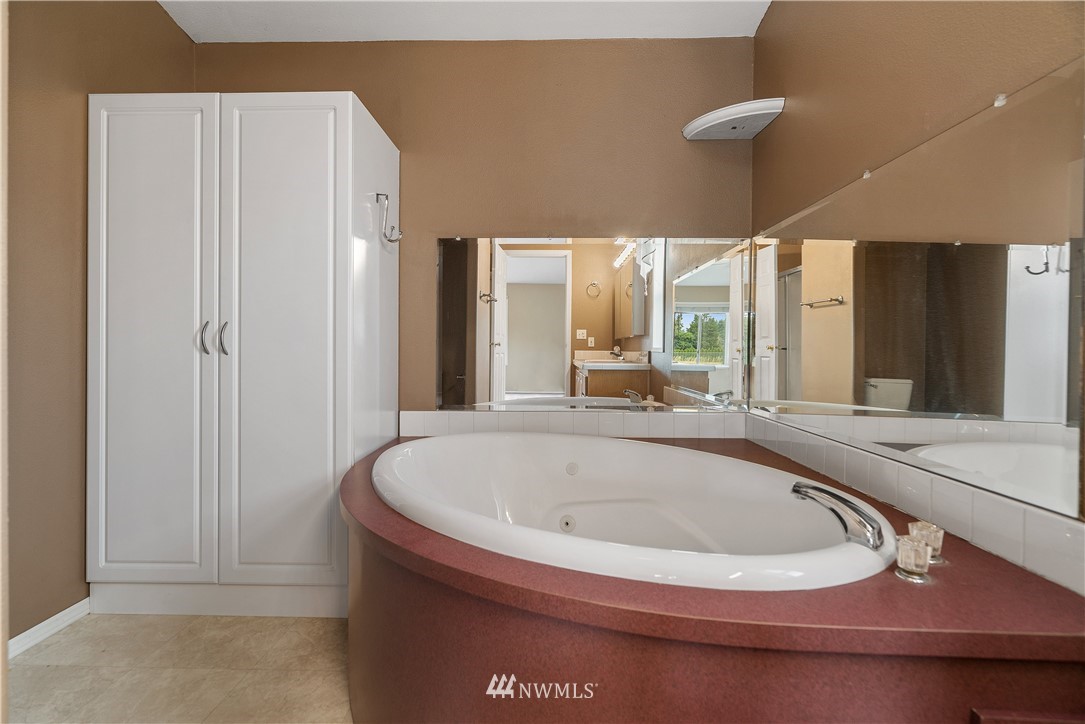 3925 183rd Avenue Southwest Rochester, WA 98579 - Photo 10 of 33 a bathroom with a tub and shower
