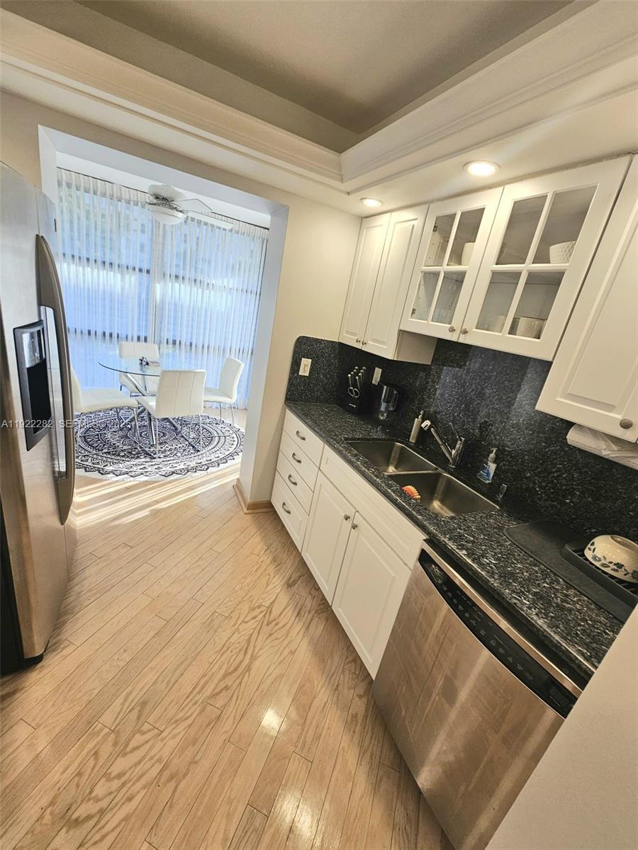 3200 South Ocean Boulevard, Unit D203 Palm Beach, FL 33480 - Photo 3 of 6 a kitchen with a sink a stove and a refrigerator