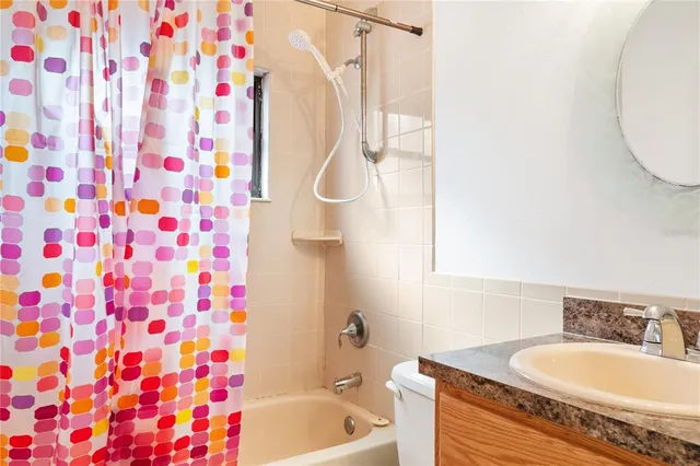a view of a small space with wooden floor and a window