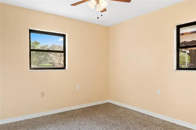 an empty room with windows and closet