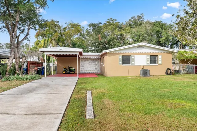a front view of house with yard patio and green space