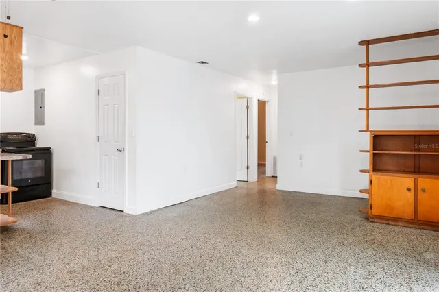 a kitchen with granite countertop a stove and a wooden floors