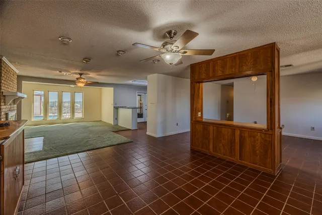 a view of hallway with a large mirror and a ceiling fan
