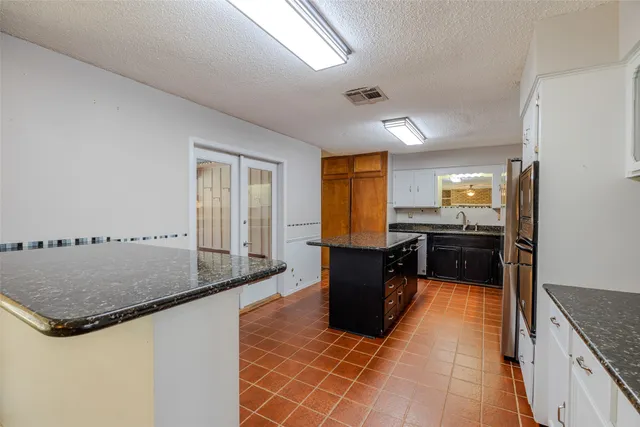 a kitchen with granite countertop a sink and counter space