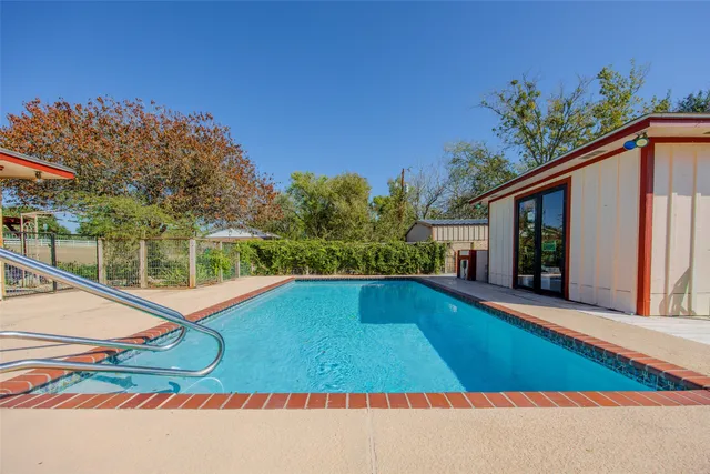 a view of swimming pool with lounge chair