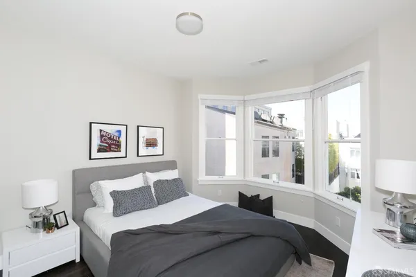 a bedroom with a large bed and a large window