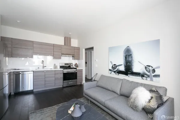 a living room with furniture and kitchen view
