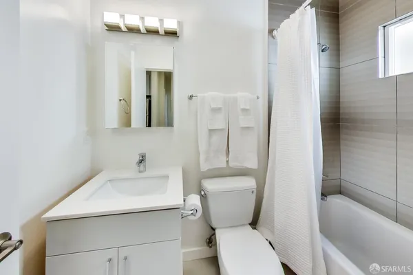 a bathroom with a toilet sink and shower