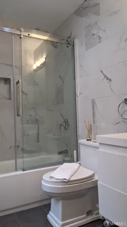 a bathroom with a white toilet and a bath tub