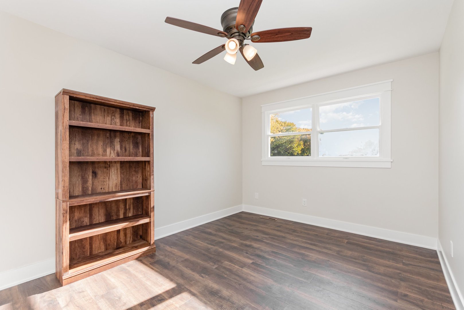 22 Sherwick Road Oswego, IL 60543 - Photo 11 of 29 a view of an empty room with a window and a ceiling fan