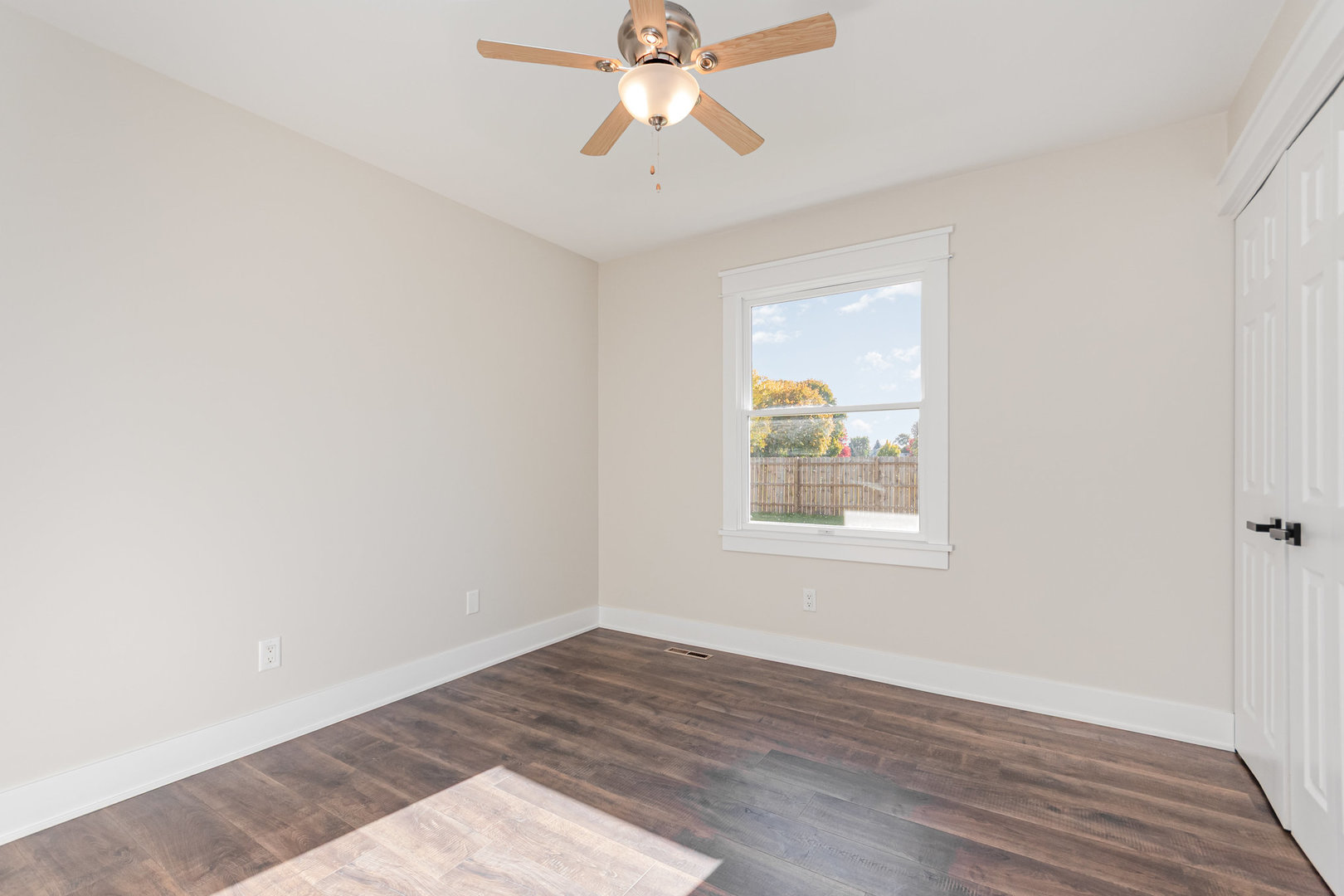 22 Sherwick Road Oswego, IL 60543 - Photo 13 of 29 an empty room with a window and a ceiling fan
