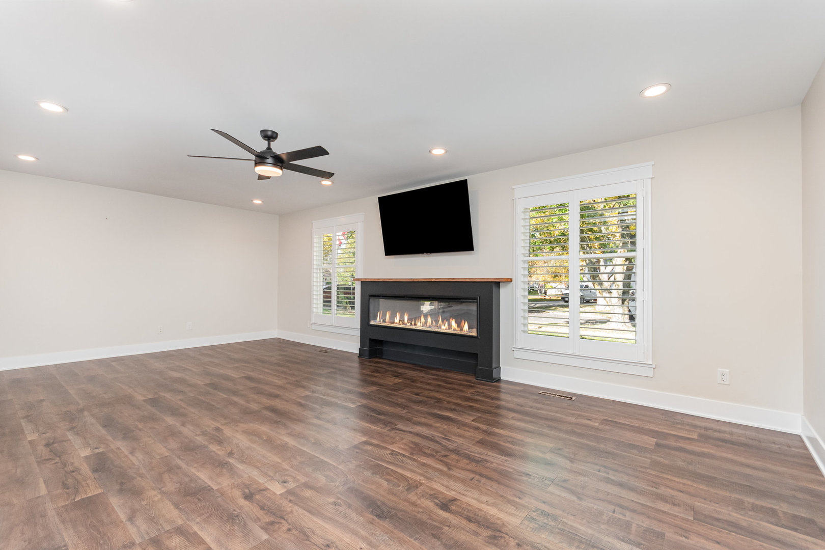 22 Sherwick Road Oswego, IL 60543 - Photo 3 of 29 a view of a livingroom with a fireplace a window and wooden floor