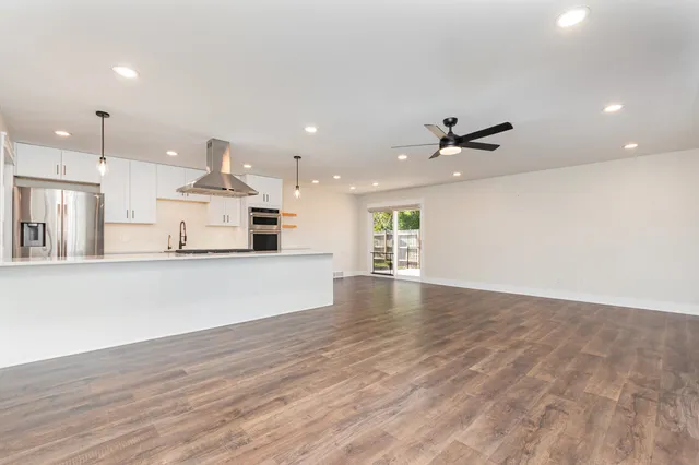 a view of a kitchen with furniture and a wooden floor