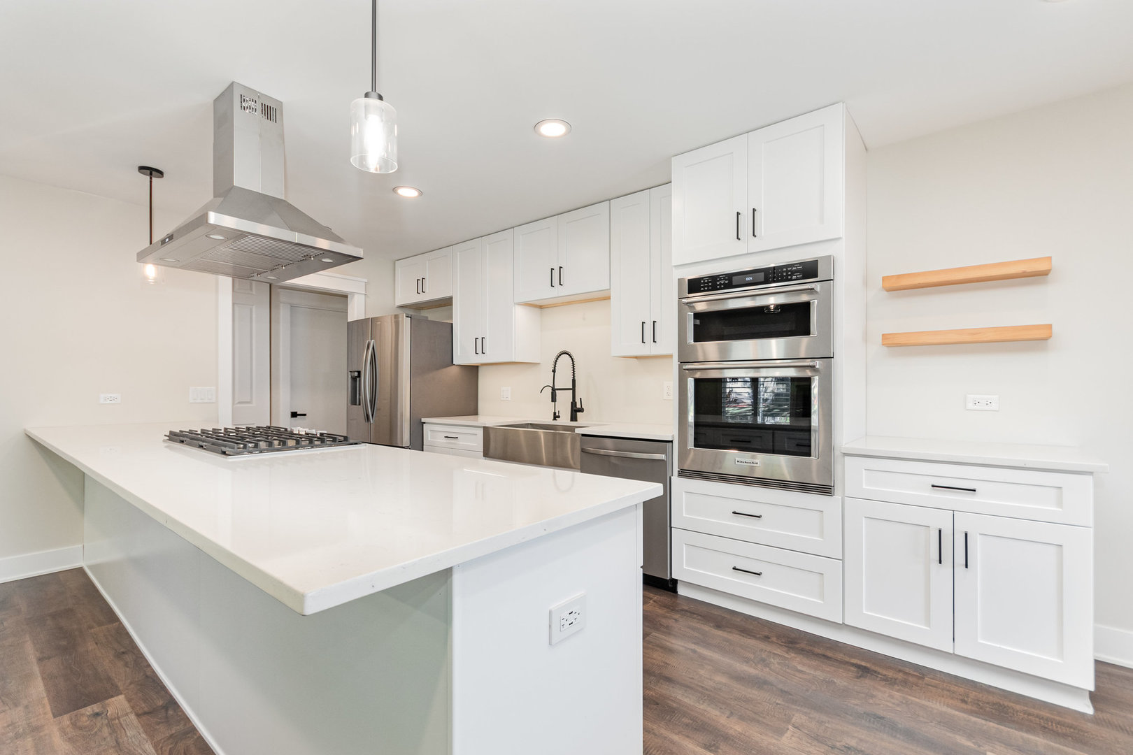 22 Sherwick Road Oswego, IL 60543 - Photo 6 of 29 a kitchen with stainless steel appliances a stove a microwave and white cabinets