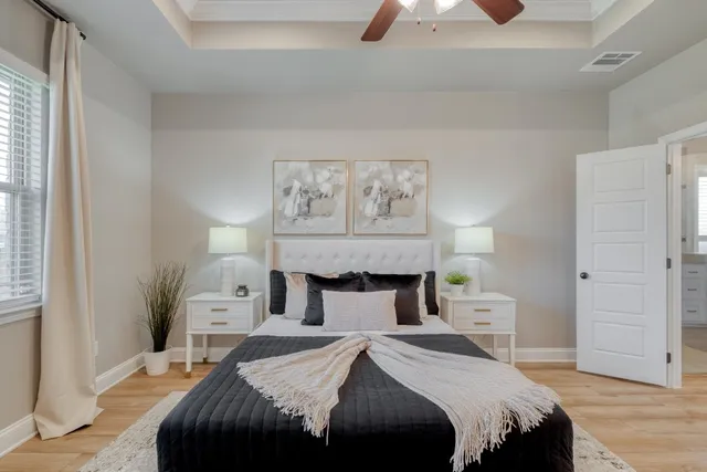 a bedroom with a bed and a chandelier