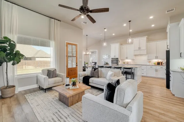 a living room with furniture and a large window